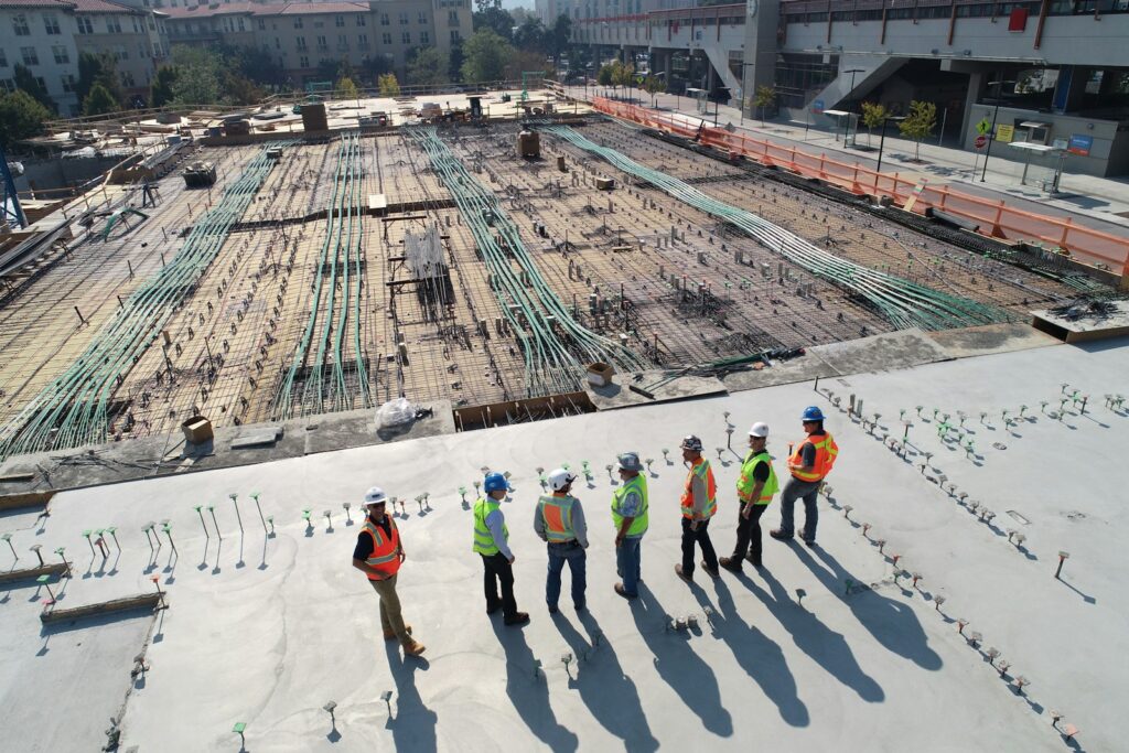 Photo by Scott Blake seven construction workers standing on white field