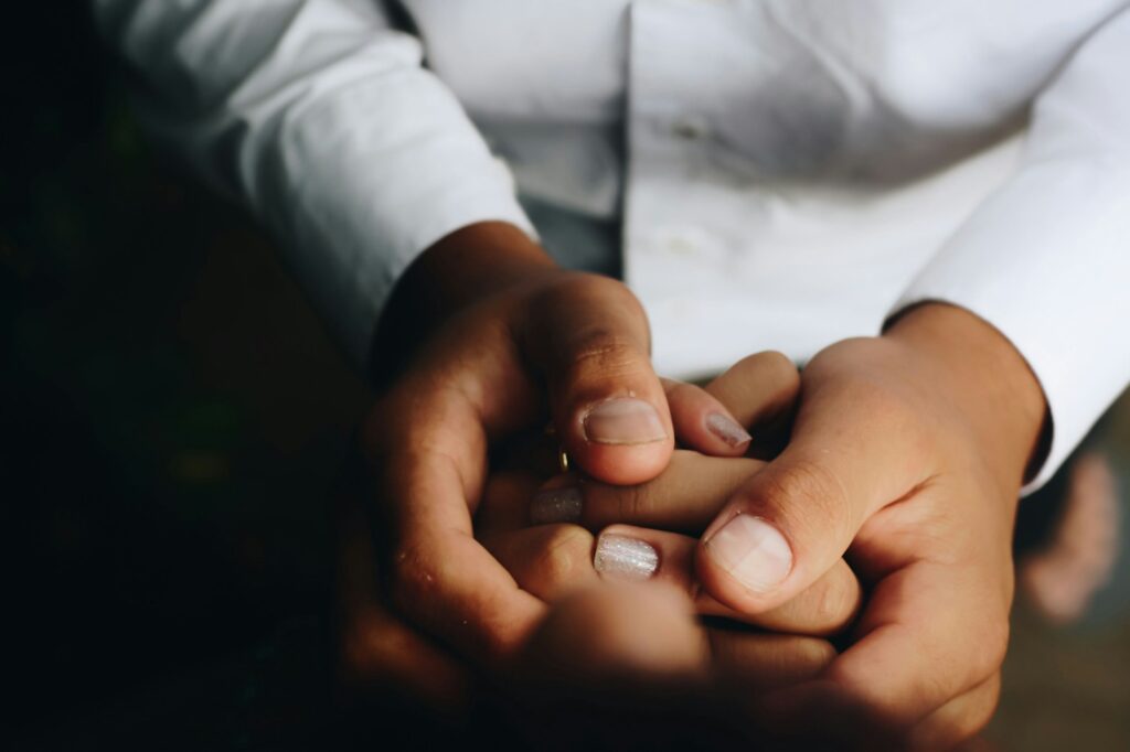 Photo by Matheus Ferrero person holding hands